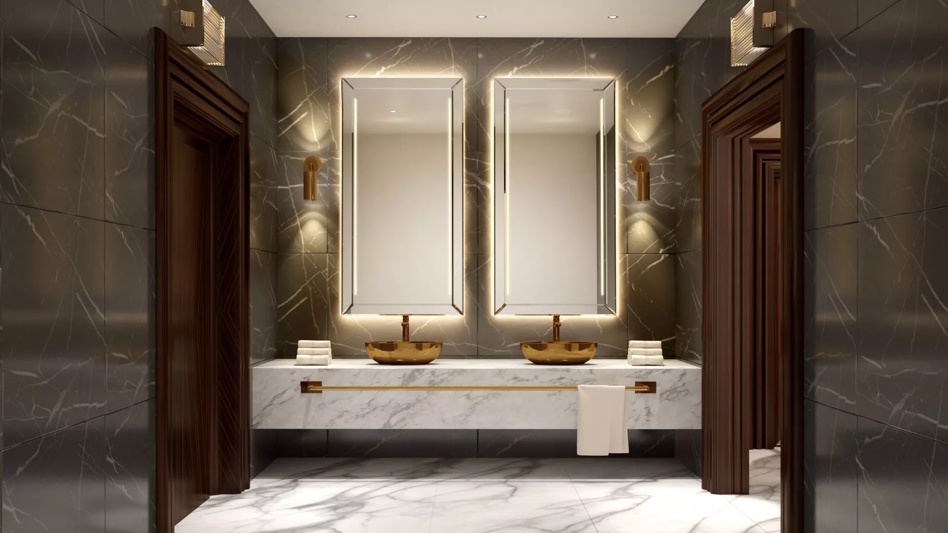 Above the double golden sink in a tiled wall are two wall lighted mirrors from Abu Dhabi.