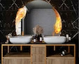 A designed bathroom sink is an emblem of a capriola light on a circular modern mirror from Ajman.
