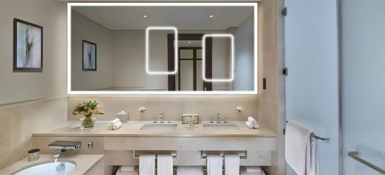 A bathroom featuring blue tiles and a mirror, creating a serene and modern atmosphere in Dubai.