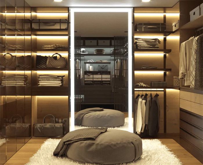 Walk in closet with a full length custom lighted mirror and a bean bag above a fur carpet in Dubai.