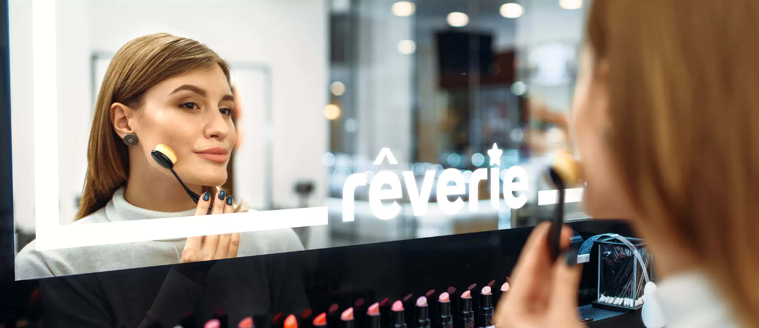 The image of a woman applying cosmetics in a make up mirrors with lights from Dubai.