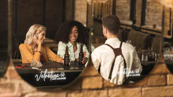 A mini reflection of three individuals in a mirror glass with led light from Fujairah.