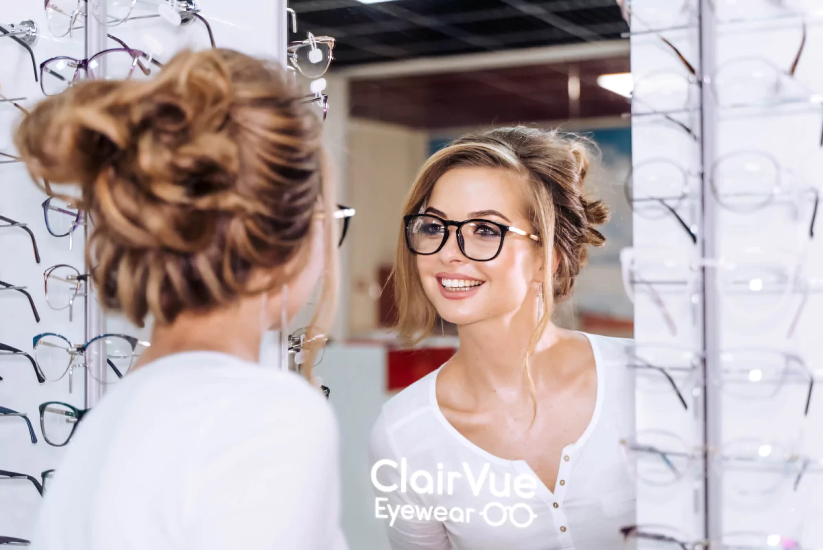 Woman testing on glasses in a built in mirror glass with led light, loving her reflection from Oman.