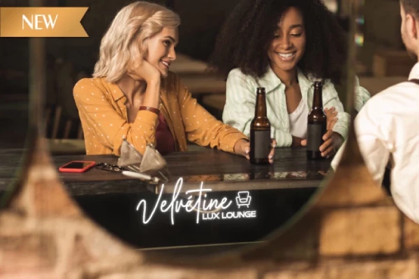 Grand Mirrors logo with velvetine lux lounge logo and a reflection of two women drinking in Oman.