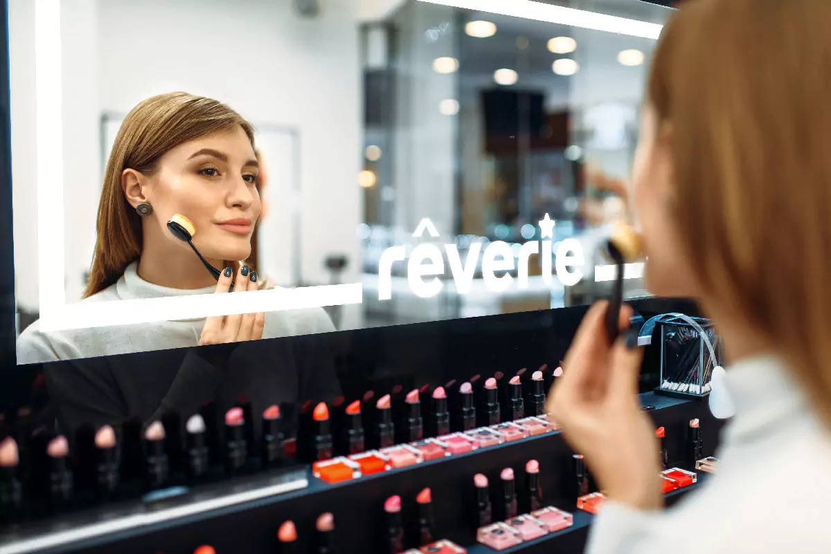 A woman is doing makeup in front of a makeup mirror with lights often gazing at her face from Qatar.