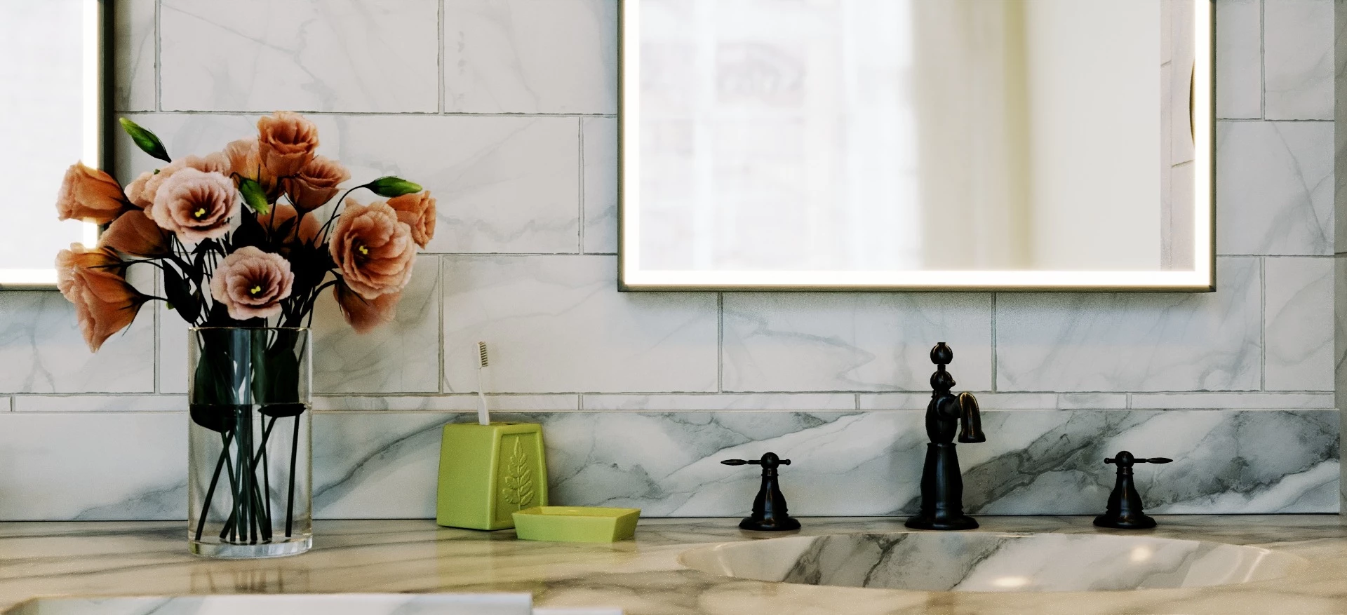 Bathroom vanity with a faucet, a flower, and a boxy lighted mirror mounted on a carrara marble wall.