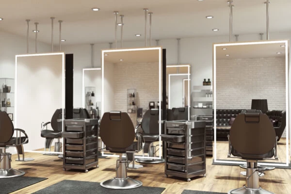 Modern salon with Salon Mirrors With Lights, styling chairs, and organized workstations.