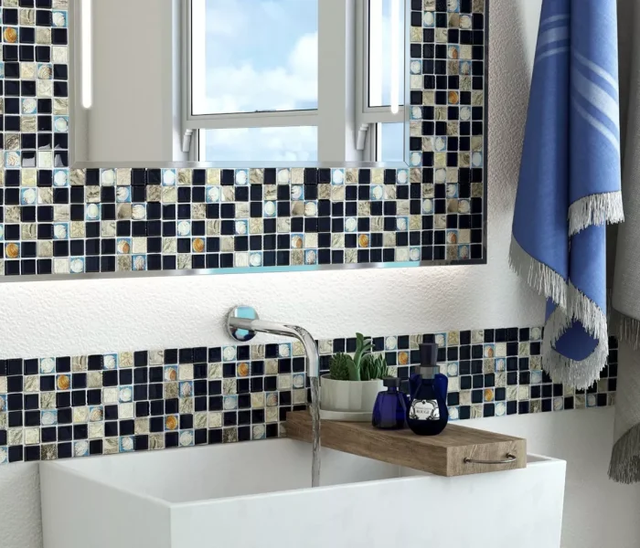 A modern LED bathroom mirror and lone sink mounted on white wall from Saudi Arabia.