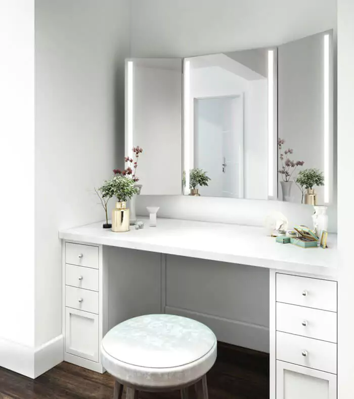 Trifold energy efficient mirror above a white wooden cabinet with a marble countertop in Sharjah.